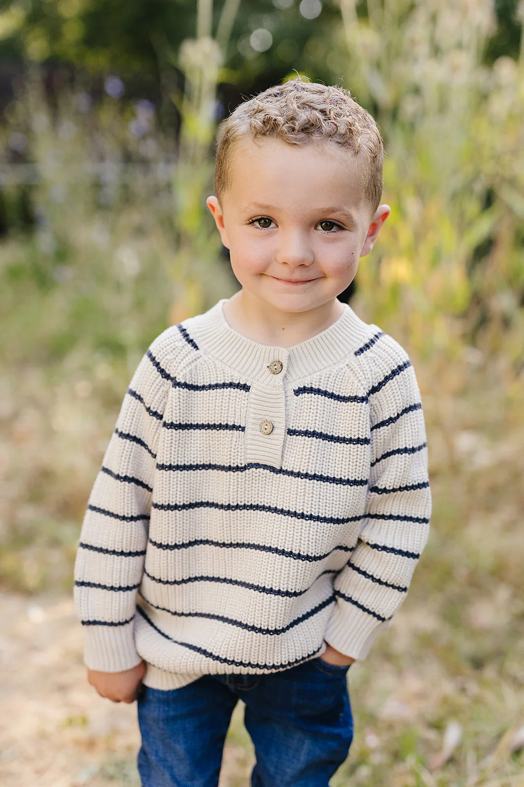 Knitted sweater with blue stripes on a white background. Mebie Baby