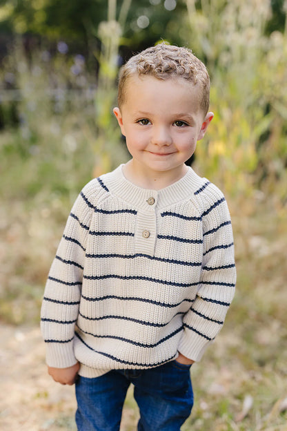 Knitted sweater with blue stripes on a white background. Mebie Baby
