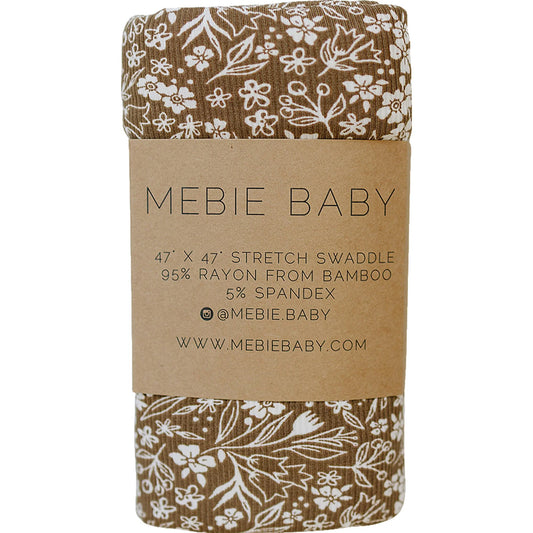 Mebie Baby stretch swaddle with floral pattern on brown paper packaging