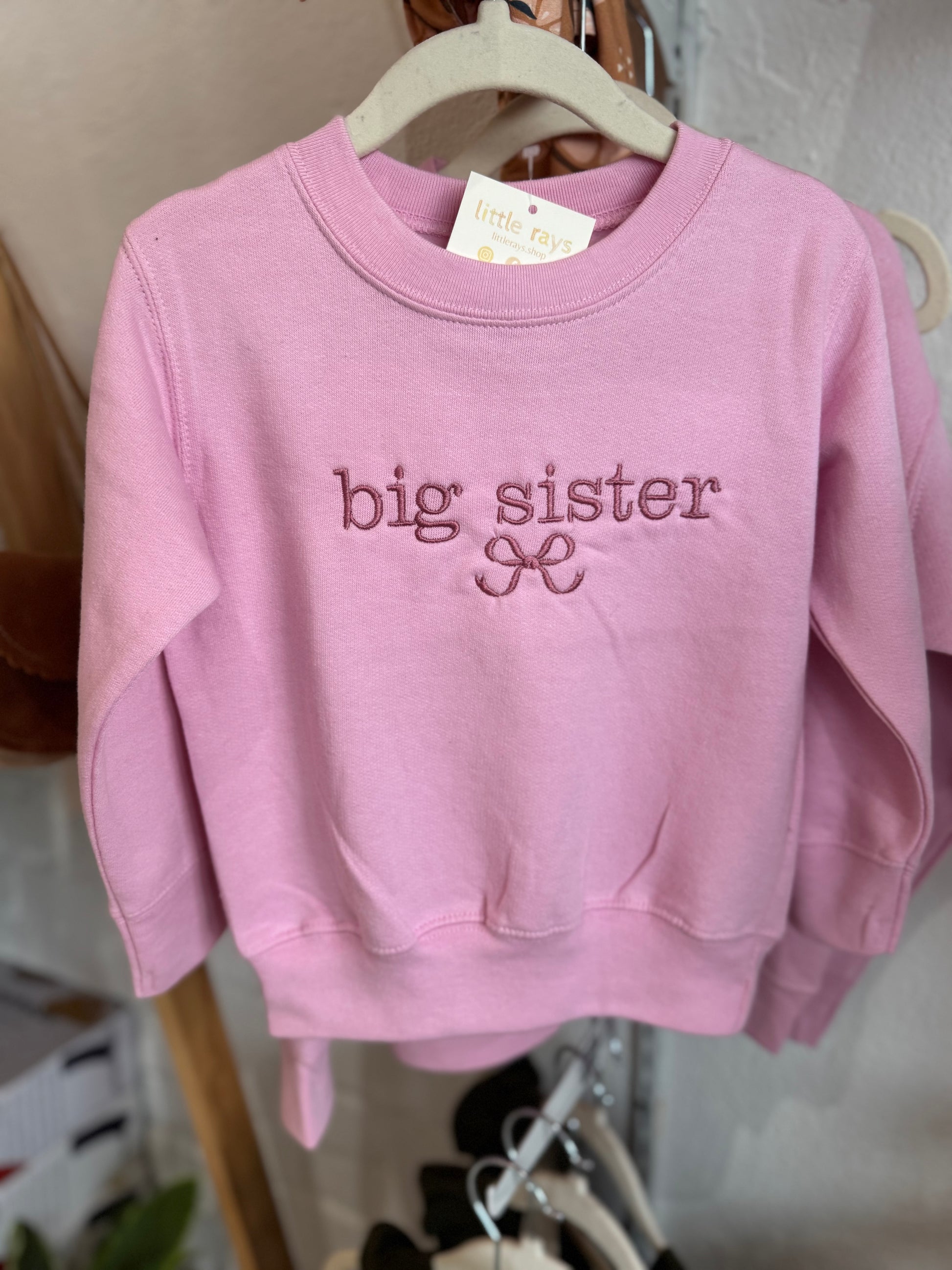 A cute big sister sweatshirt with a bow