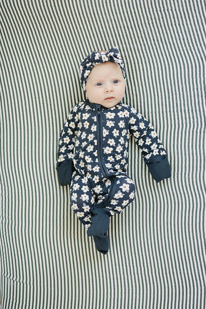 Navy baby onesie with white floral pattern on a white background. Mebie Baby
