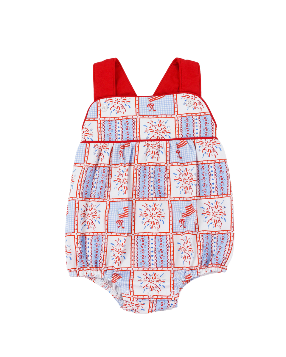 Baby romper with red straps and a pattern of stars and stripes on a white background