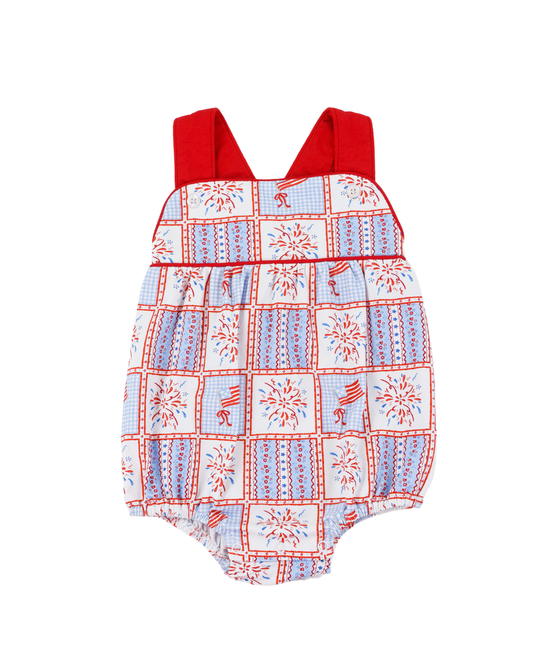 Baby romper with red straps and a pattern of stars and stripes on a white background